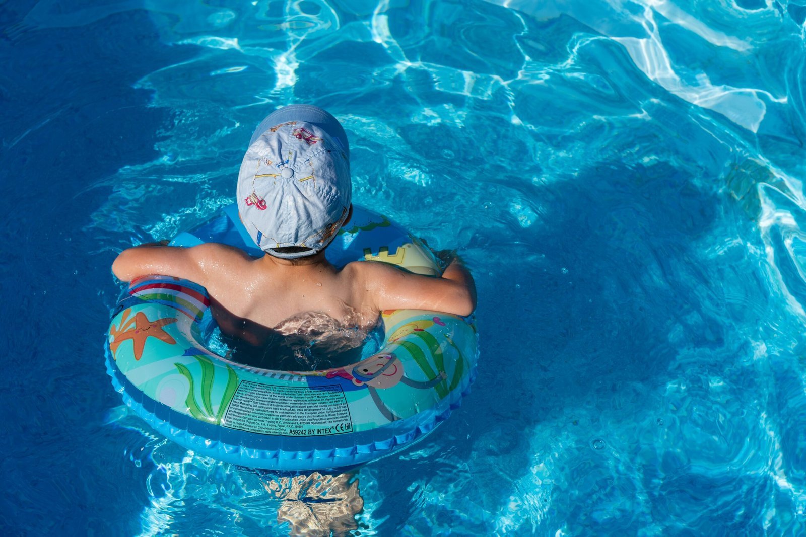 woman in blue swimming cap in pool